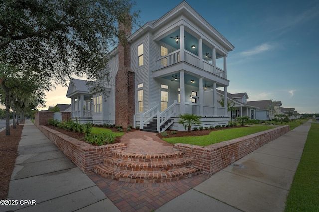 view of front of home featuring a porch, a balcony, and ceiling fan