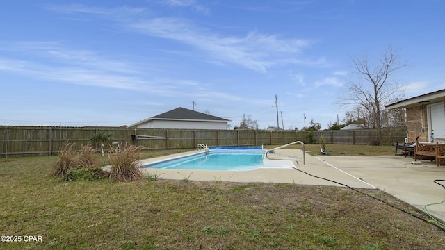 view of pool with a lawn and a patio