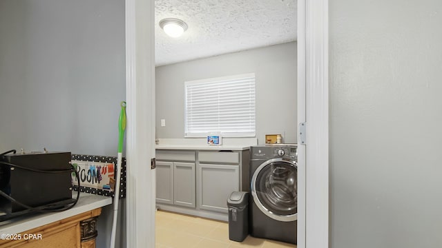 laundry area featuring a textured ceiling and washer / clothes dryer