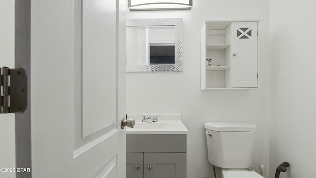 bathroom with toilet and vanity