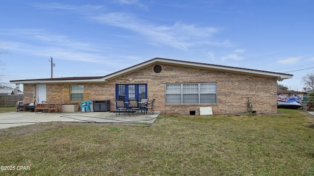 back of house with a patio area and a lawn