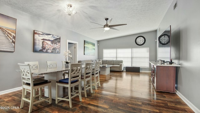 dining area featuring ceiling fan, dark wood-type flooring, and a textured ceiling