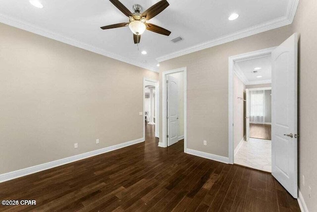 unfurnished bedroom featuring dark hardwood / wood-style flooring, ceiling fan, and crown molding