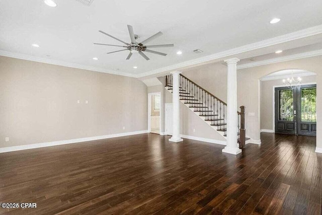 unfurnished living room with ceiling fan with notable chandelier, crown molding, and dark hardwood / wood-style floors