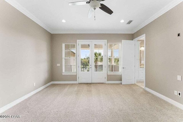 spare room featuring ceiling fan, light colored carpet, french doors, and ornamental molding