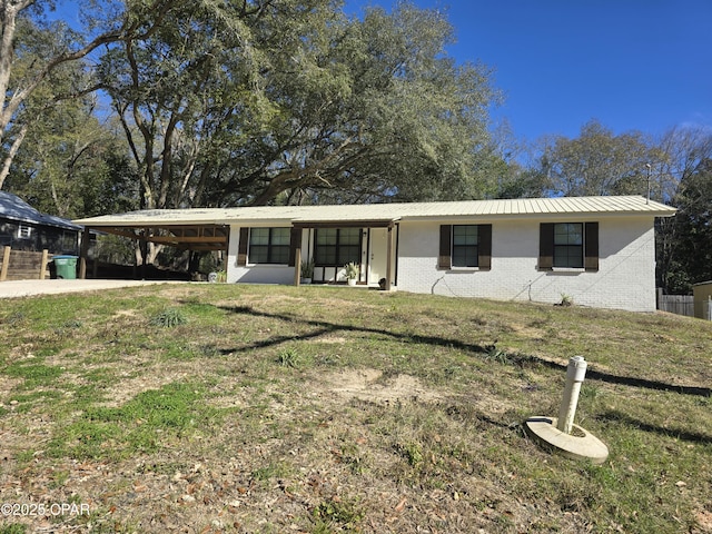 ranch-style house with a carport and a front lawn