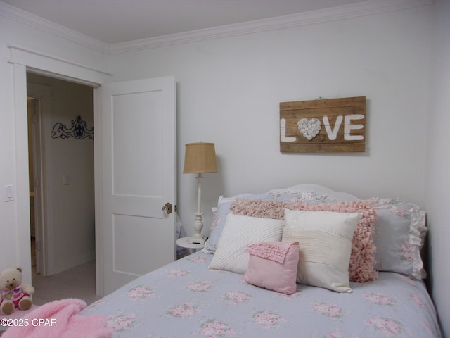 bedroom featuring ornamental molding and carpet flooring