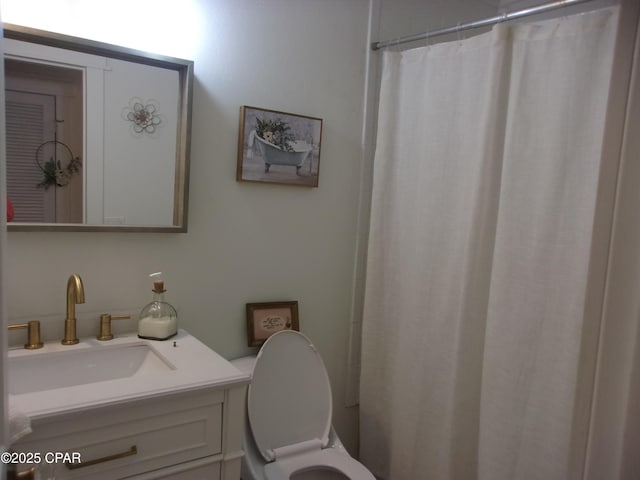 bathroom with vanity, a shower with curtain, and toilet