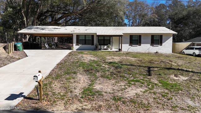 ranch-style house featuring a carport