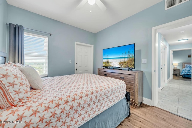 bedroom with ceiling fan and light hardwood / wood-style floors