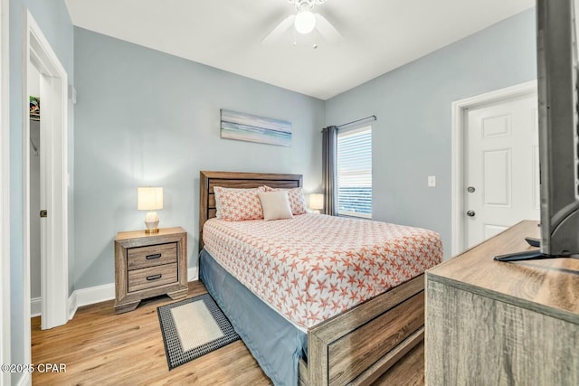 bedroom with light wood-type flooring and ceiling fan