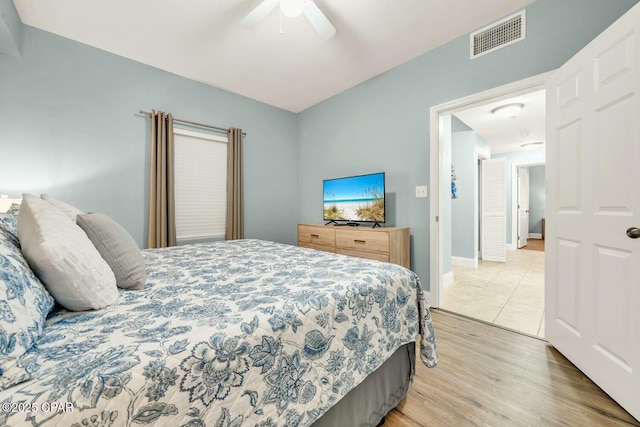 bedroom with wood-type flooring and ceiling fan