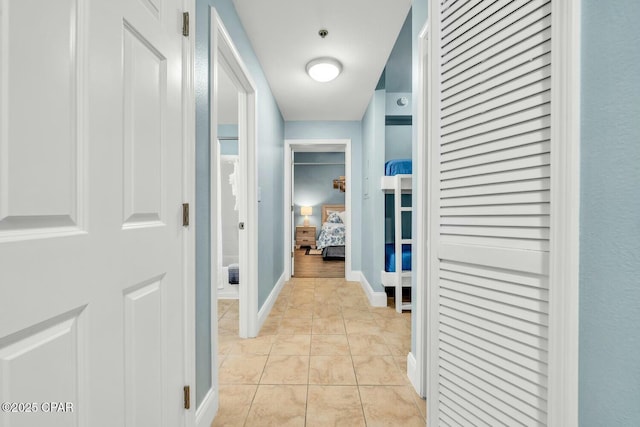 hall with light tile patterned floors