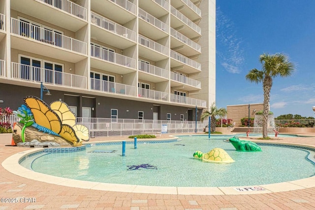 view of swimming pool with pool water feature