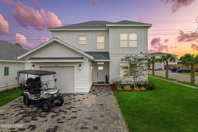 view of front facade featuring a yard and a garage