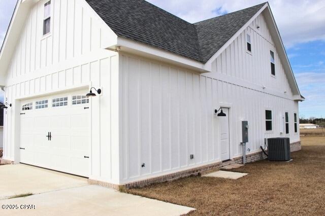 view of home's exterior with central AC and a garage