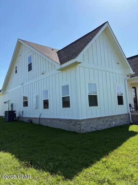 3391 Grey Oak Way, Marianna, FL 32446 - view of property exterior with board and batten siding, a shingled roof, and a yard