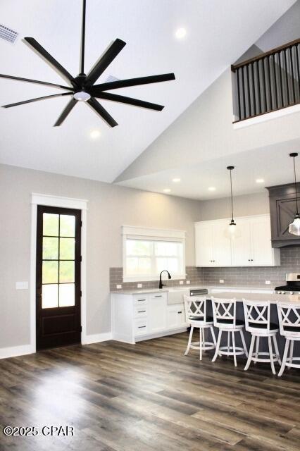 kitchen with dark hardwood / wood-style flooring, ceiling fan, pendant lighting, and white cabinetry