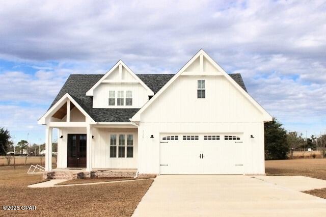 modern inspired farmhouse with a garage