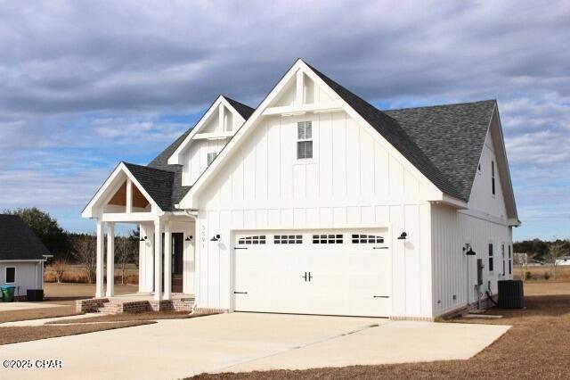 modern farmhouse style home with central AC and a garage