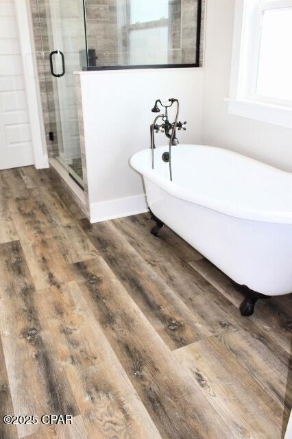 bathroom featuring hardwood / wood-style flooring and separate shower and tub