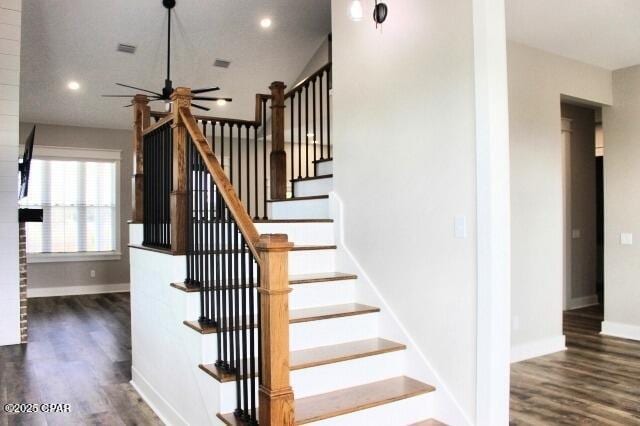 staircase with ceiling fan and wood-type flooring