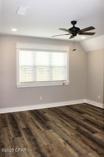 empty room with ceiling fan, dark wood-type flooring, and lofted ceiling