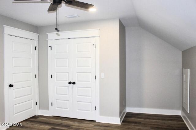 interior space featuring ceiling fan, a closet, vaulted ceiling, and dark hardwood / wood-style floors