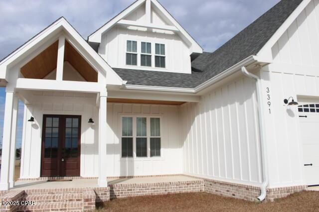 rear view of property with a garage