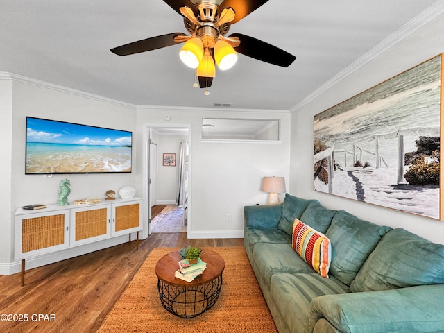 living room featuring ceiling fan, ornamental molding, and hardwood / wood-style floors