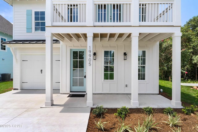 doorway to property featuring central air condition unit and a garage