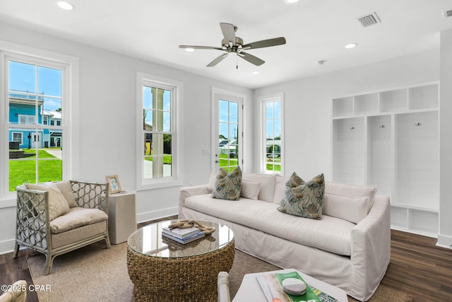 living room with ceiling fan and dark hardwood / wood-style flooring