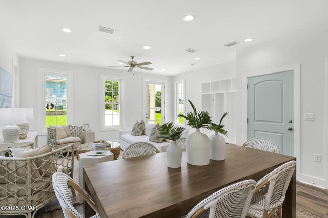 dining area with dark wood-type flooring and ceiling fan