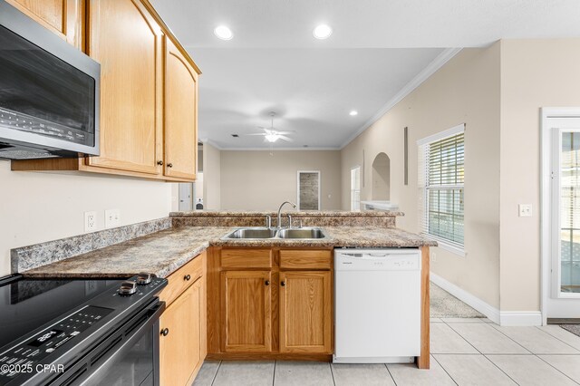 kitchen featuring stainless steel microwave, white dishwasher, a sink, black range with electric cooktop, and a peninsula