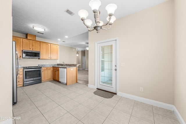 kitchen with light tile patterned floors, stainless steel appliances, visible vents, a sink, and a peninsula