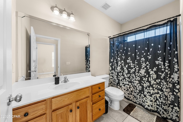 bathroom featuring visible vents, a shower with shower curtain, toilet, vanity, and tile patterned flooring