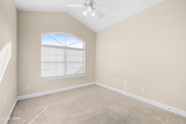 carpeted empty room with a ceiling fan, lofted ceiling, and baseboards