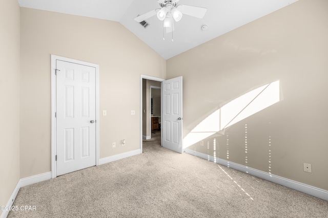 unfurnished bedroom with carpet, visible vents, vaulted ceiling, and baseboards