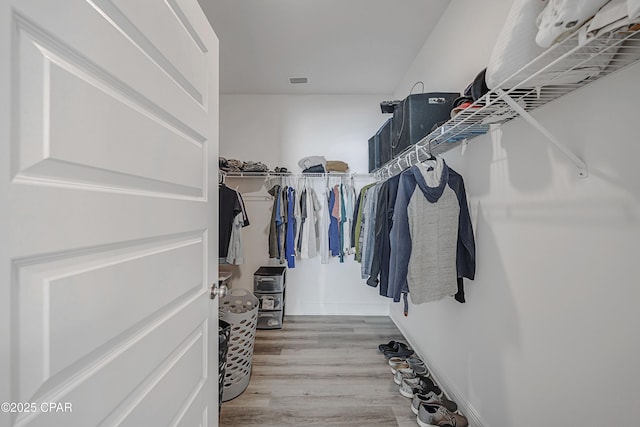 walk in closet featuring light hardwood / wood-style floors