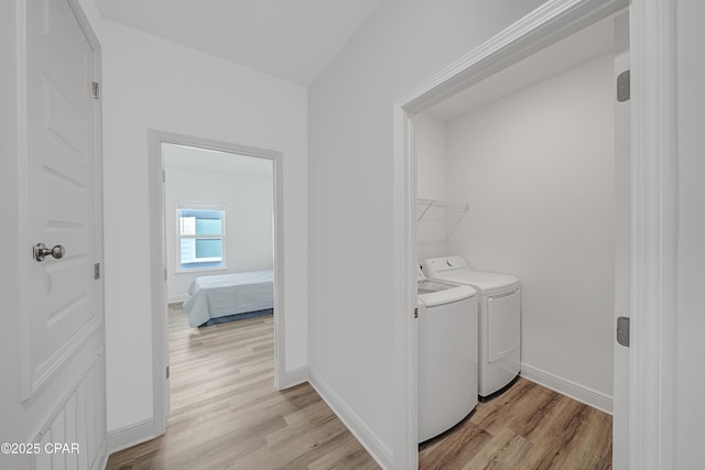 laundry room featuring independent washer and dryer and light wood-type flooring