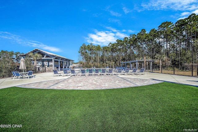 view of swimming pool with a yard and a pergola