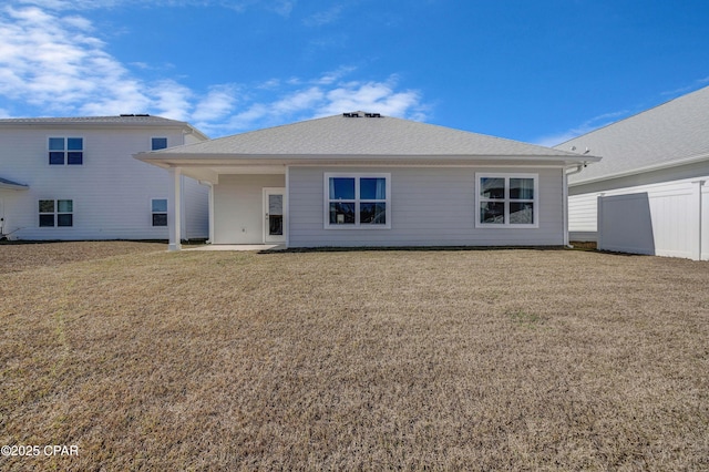 rear view of property featuring a yard