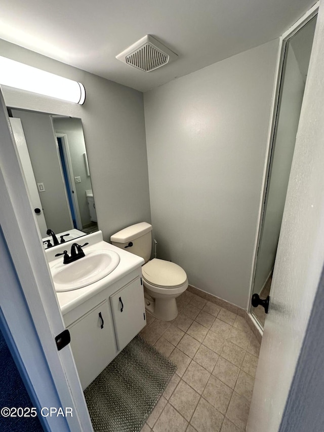 bathroom with tile patterned floors, toilet, and vanity