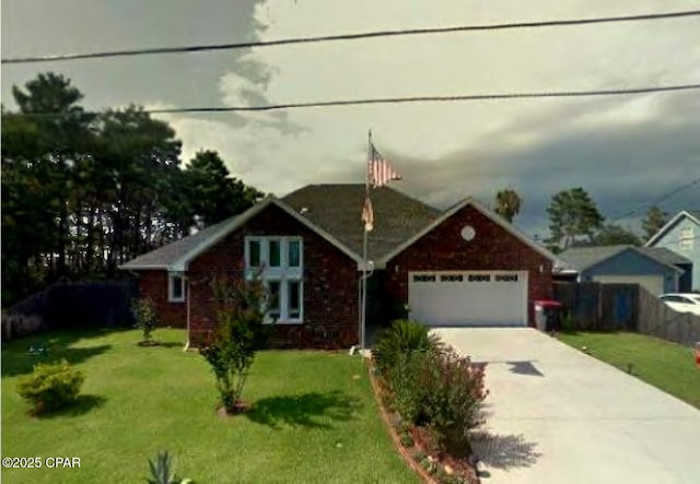 view of front of house featuring a garage and a front yard