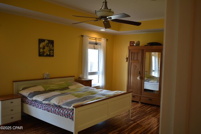 tiled living room featuring ceiling fan, ornamental molding, and a tray ceiling