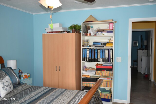 bedroom with ornamental molding and ceiling fan