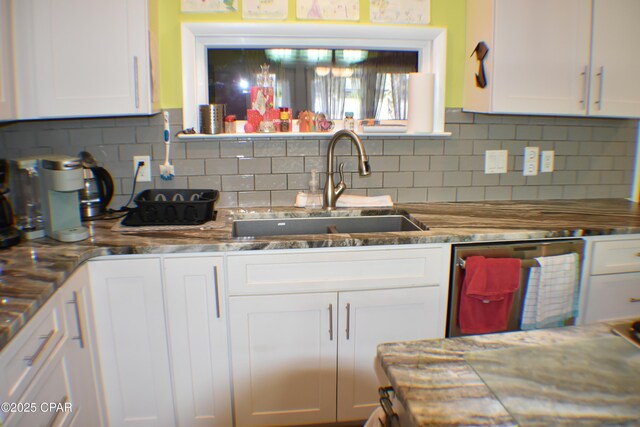 kitchen featuring light tile patterned floors, light stone counters, white refrigerator with ice dispenser, white cabinets, and stainless steel gas stovetop