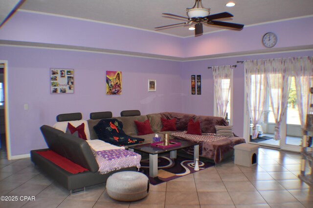 tiled living room with a raised ceiling and ceiling fan