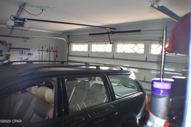 garage featuring a garage door opener and a workshop area