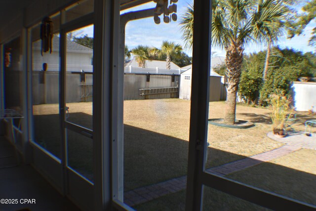 sunroom featuring ceiling fan